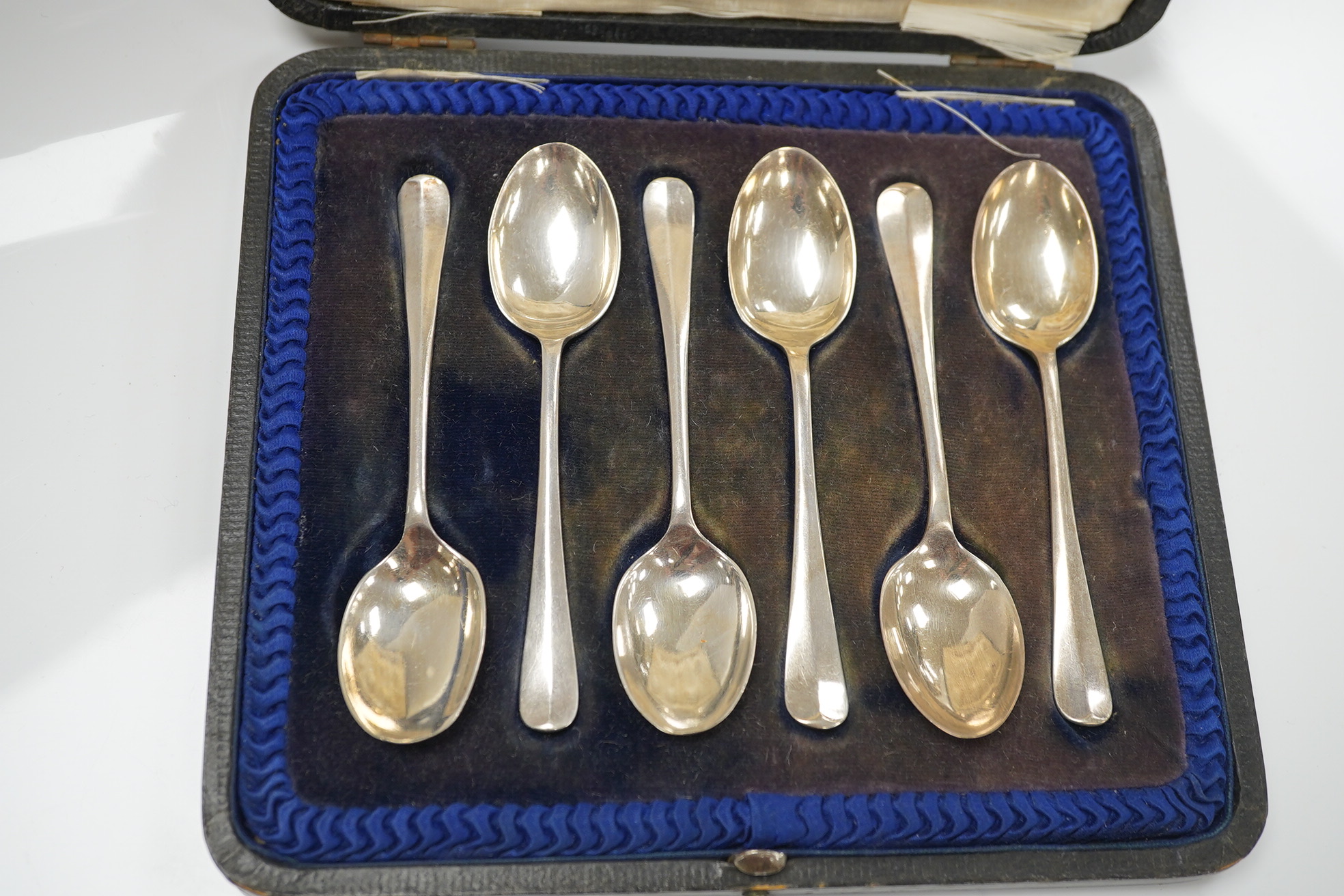 A cased set of six George V silver teaspoons and a cased pair of glass butter dishes with two silver butter knives. Condition - fair to good